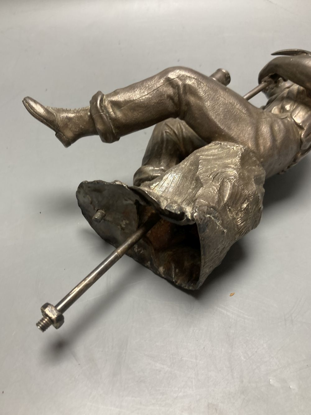 A Victorian silver plated model of a seated tin miner